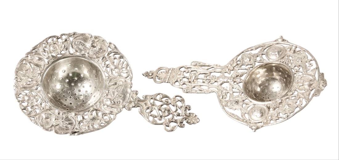 (2) Vintage Sterling Silver Articulated Repousse Tea Strainers: Two vintage sterling silver articulated repousse tea strainers height 5.5 in. x width 3.5 in. x depth 1 in. / each Total weight: 3.78 ozt (weighable silver) Provenance: Property from the