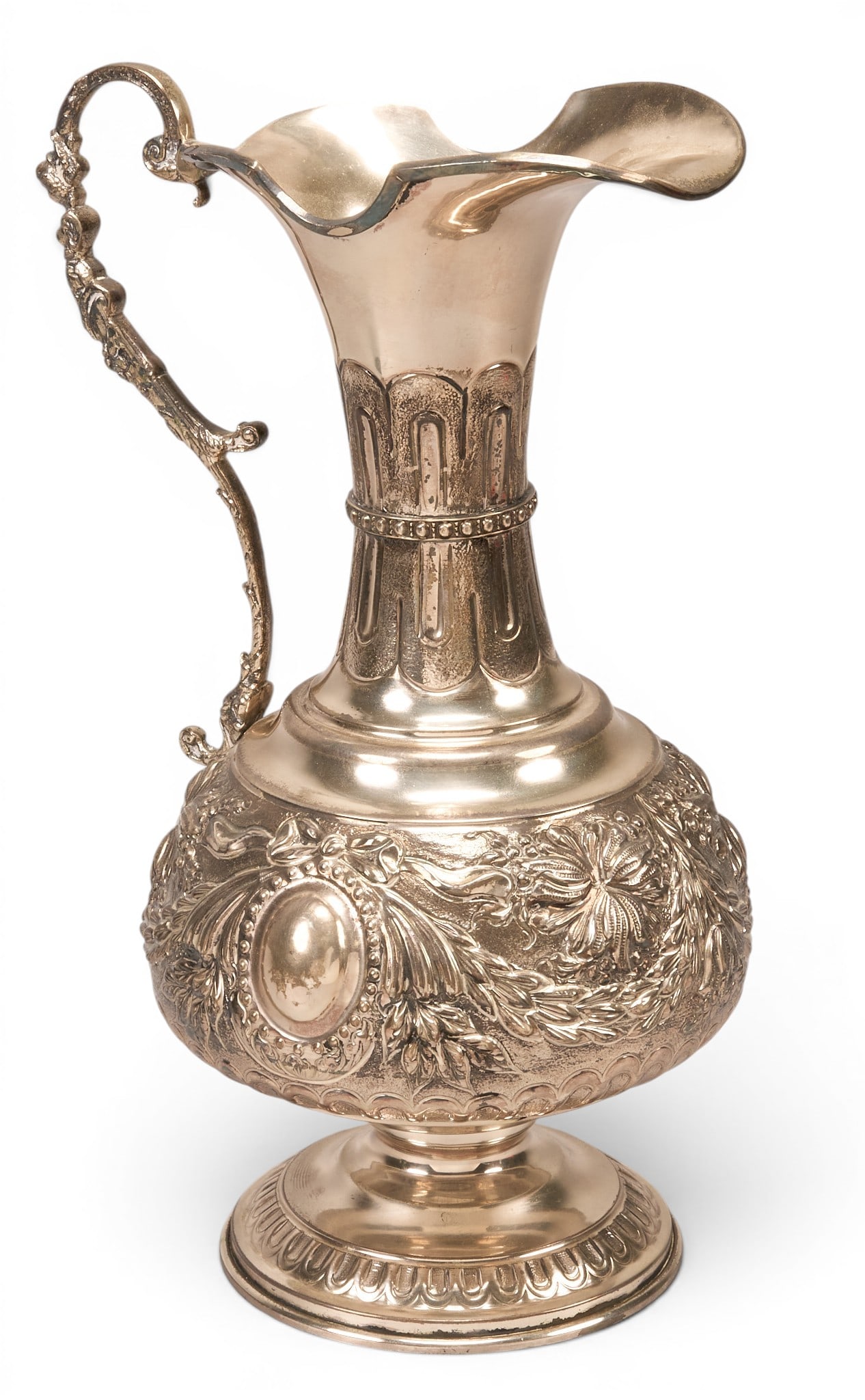 German 800 Silver Pitcher: German 800 silver pitcher featuring embossed floral and foliate motifs, centered by an oval cartouche height 13.5 in. x width 9 in. x depth 7 in. Provenance: Property from a home in San Antonio, Texas