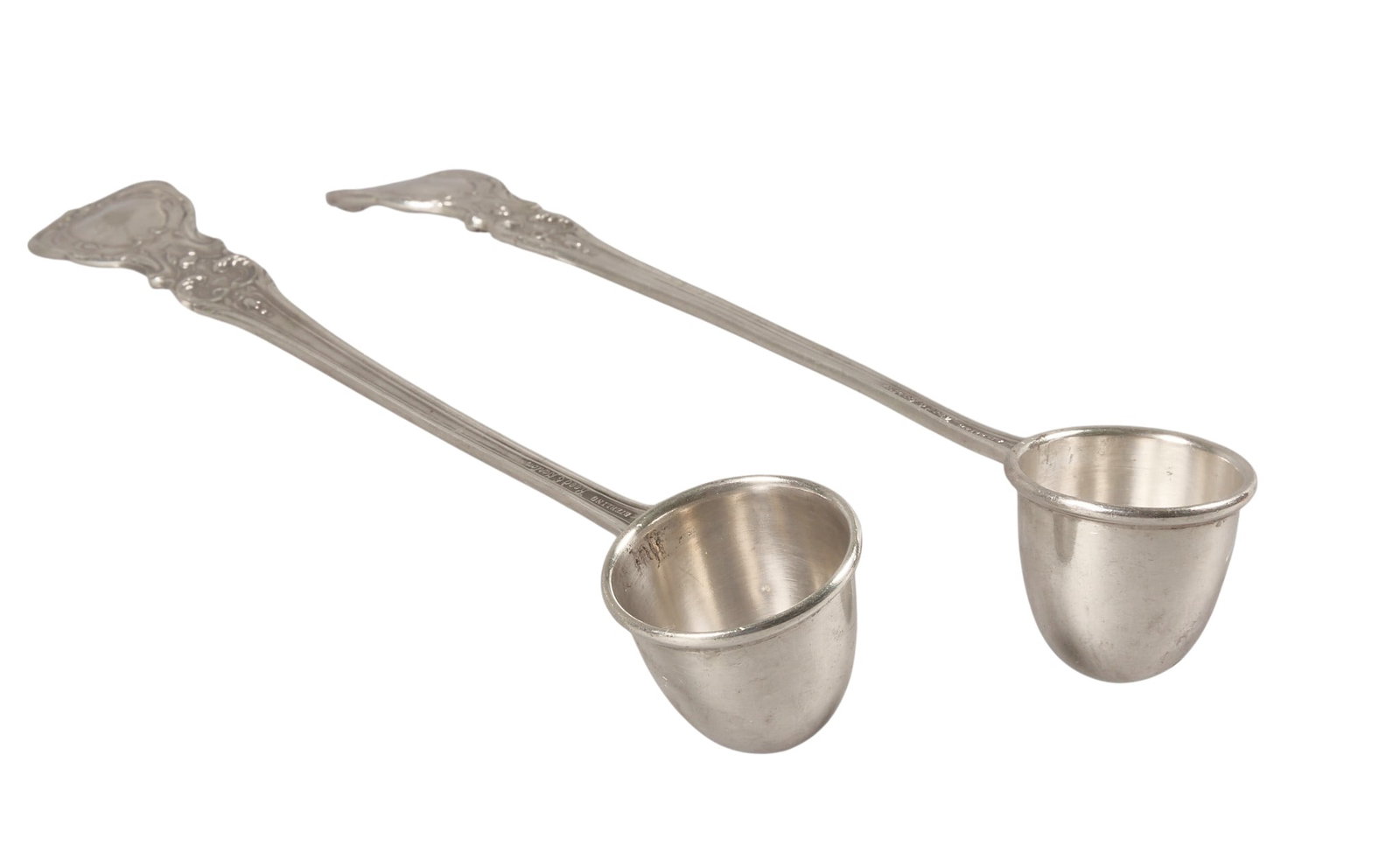 Pair of Candle Snuffers, 6.75?? Long: Pair of sterling silver candle snuffers height 1 in. x width 6.5 in. x depth 1 in. / each Total weight: 2.105 ozt (weighable silver) Provenance: Property from the collection of an