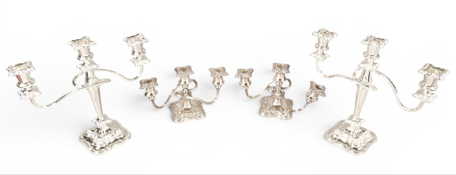 Set of (4) Silver Plated Candelabra: Set of four silver plated candelabra, weighted height 13 in. width 13.5 in. x depth 5 in. / largest Provenance: Property from a home in San Antonio, Texas 