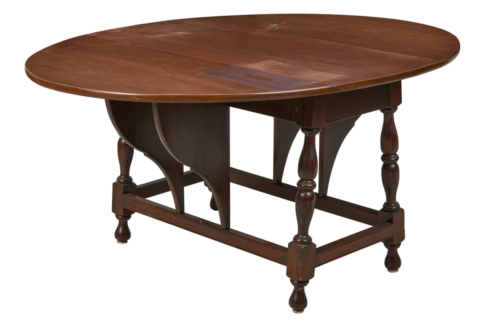 Drop Leaf Table: Drop leaf table with circular top, supported on turned stretcher legs height 29 in. x width 63 in. x depth 48 in. Provenance: Property from a home in San Antonio, Texas 