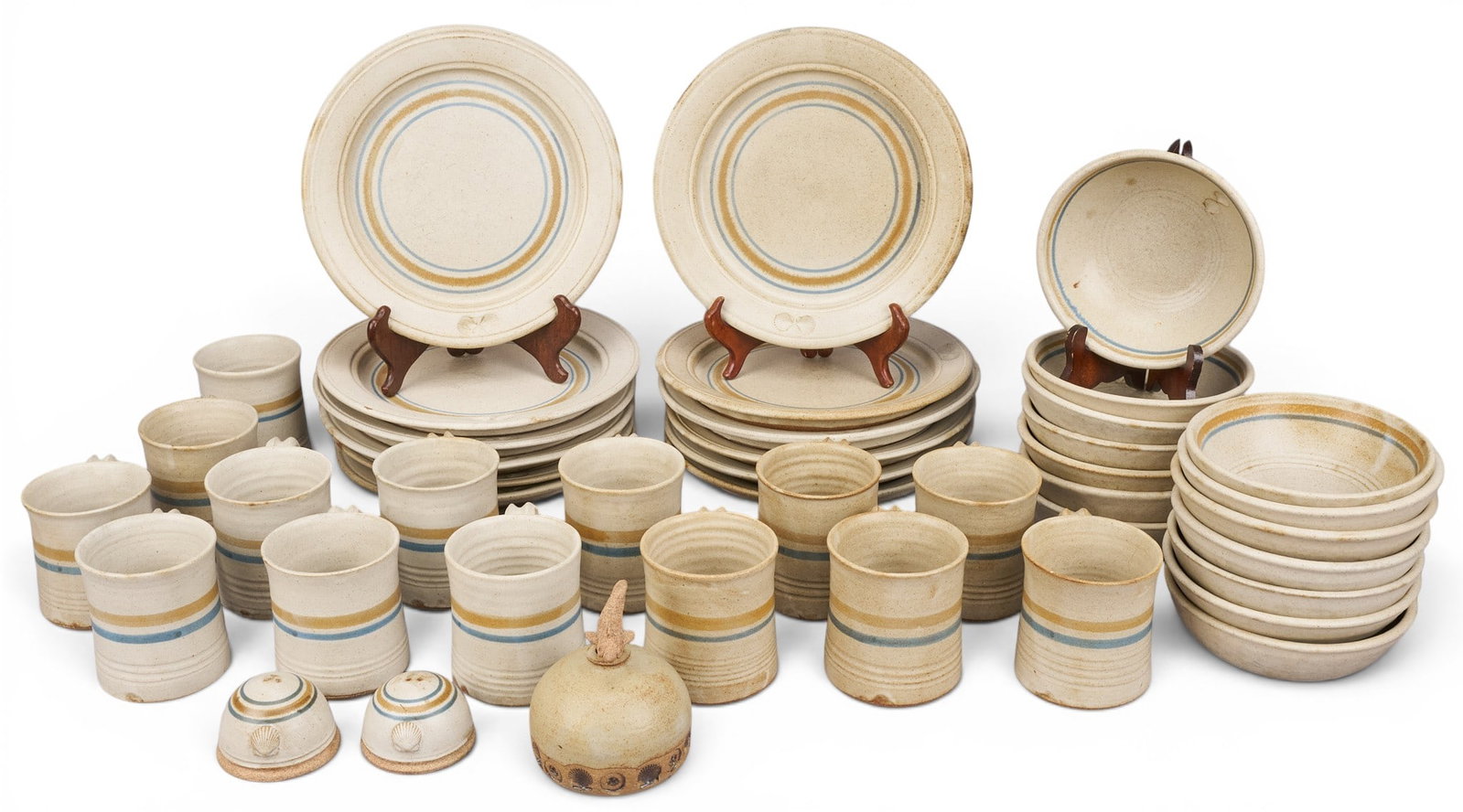 Set of Nanci Barnes Ceramics: Nanci Barnes (Rockport, Texas) pottery dinnerware set, service for twelve, includes plates, bowls, mugs, salt and pepper shakers, vessel with fish stopper, all with speckled beige