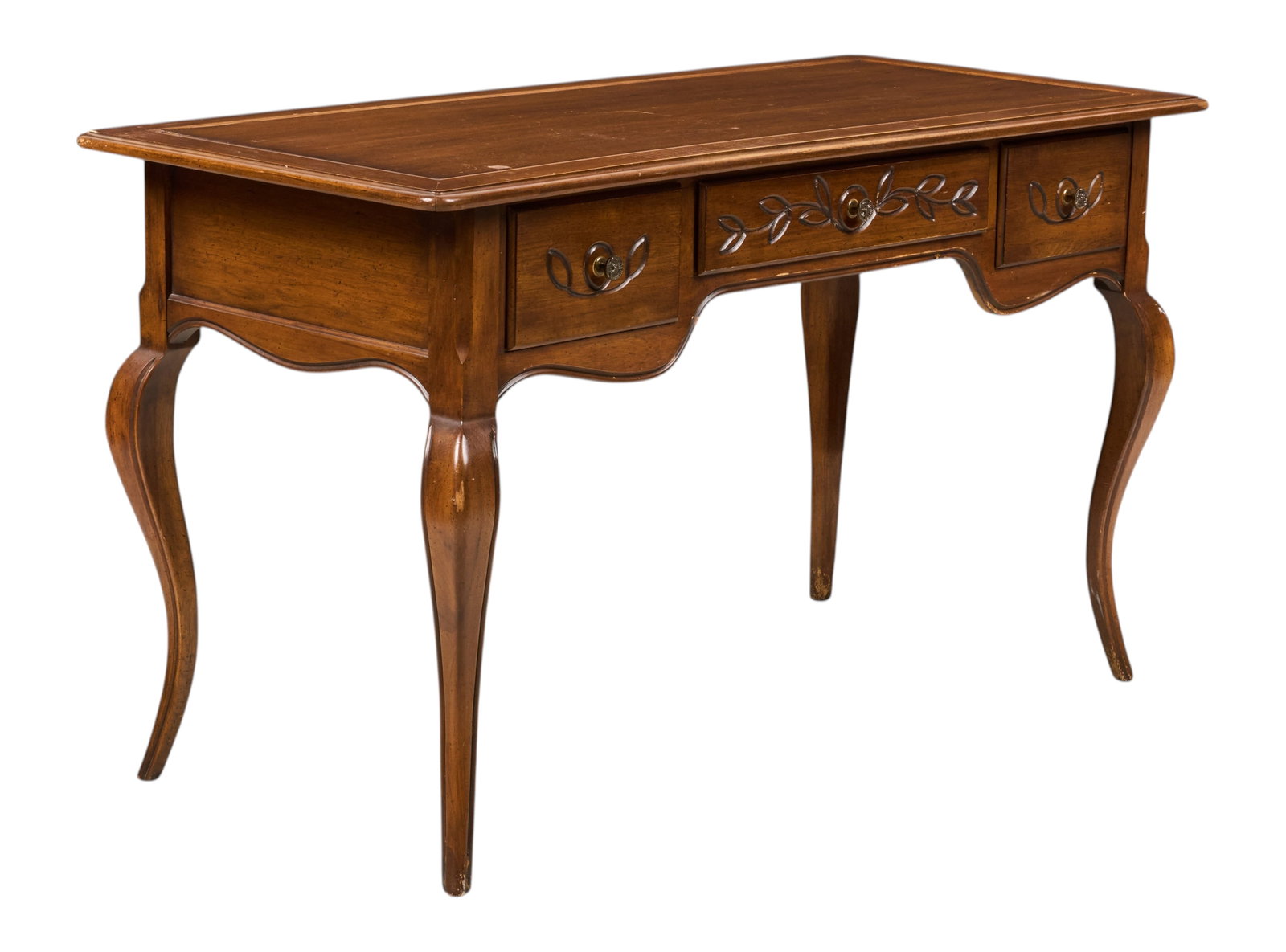 French Provincial Desk: French Provincial style desk featuring carved vine detailing on drawers, supported on cabriole legs height 30.5 in. x width 53 in. x depth 24 in. Provenance: Property from a home in Boerne, Texas