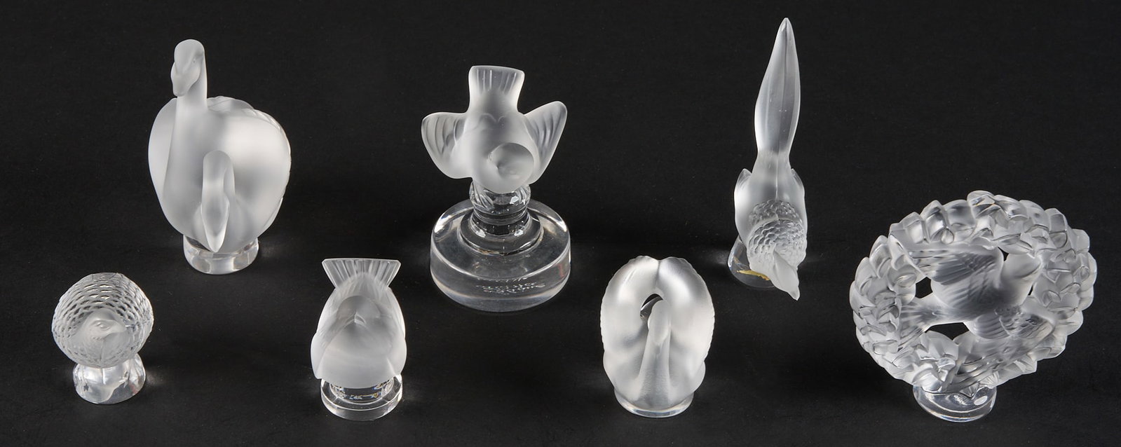 (7) Small Lalique Bird Figures: Seven Lalique crystal bird figurines, various birds such as swans, doves and quail, all signed on base height 3.25 in. x width 3 in. x depth 1 in. / largest Provenance: Property from a home in S