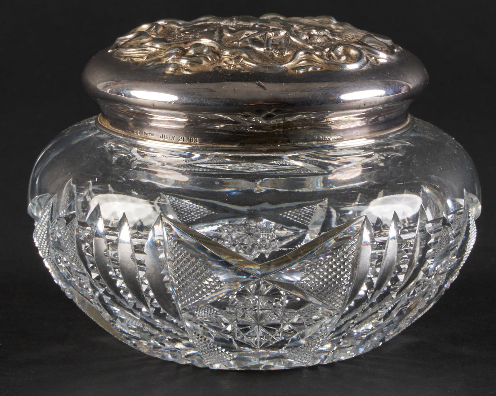 Sterling and Crystal Jar: Vintage cut crystal jar with repousse sterling silver lid depicting the birth of Venus, marked "Sterling 3077", and dated July 21, '03 height 3.5 in. x diameter 5 in. weighable ste