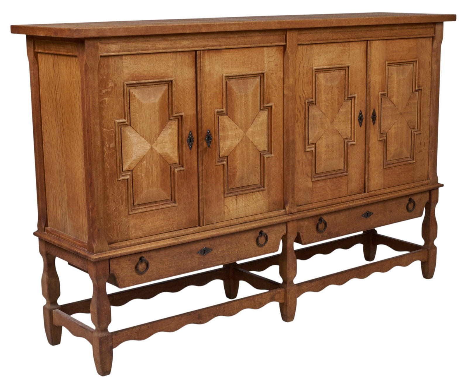 Henning Kjaernulf, Mid-Century Credenza: Henning Kjaernulf (Denmark) oak mid-century credenza with four carved cabinet doors opening to fitted interior with shelves and flatware trays, above two drawers with metal pulls, supported on shaped