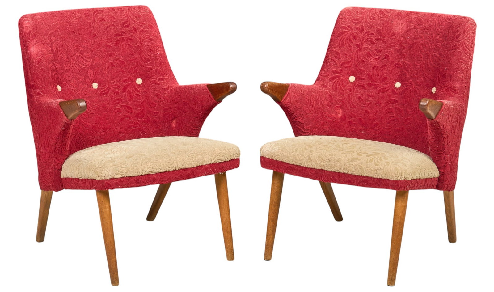 Pair of Danish Mid-Century Upholstered Armchairs: Pair of Danish mid-century armchairs, upholstered in red patterned fabric with contrasting cream seats and button accents, exposed sculptural wood hand rests, raised on splayed tapered legs, circa 195