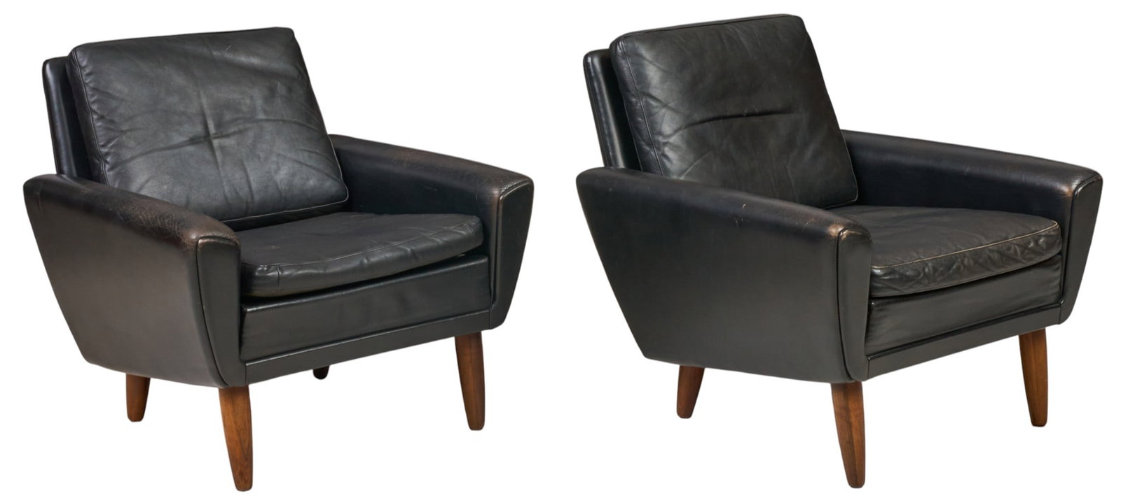 Pair of Danish Mid-Century Leather Armchairs: Pair of Danish mid-century black leather armchairs with removable cushions and padded armrests, raised on splayed pin legs height 28.5 in. x width 29.5 in. x depth 32 in. / each