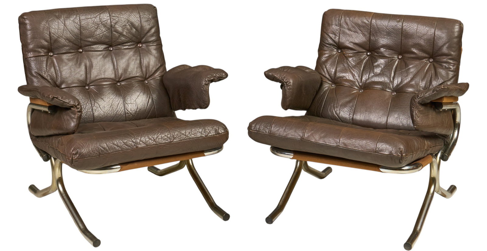 Pair of Danish Mid-Century Leather Armchairs: Pair of Danish mid-century armchairs upholstered in dark brown tufted leather, featuring chrome frames with wooden accents height 30.5 in. x width 30 in. x depth 34 in. / each