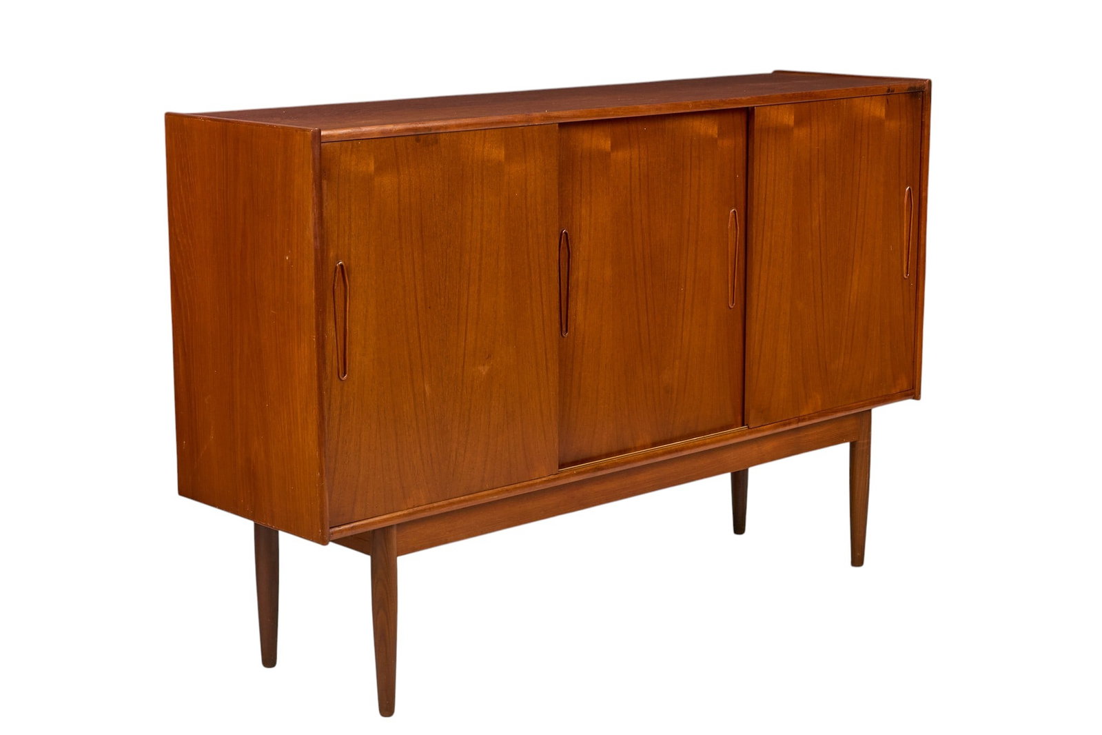 Danish Mid-Century Credenza: Danish mid-century credenza with three sliding doors that open to interior with adjustable shelving and two green felt-lined trays, supported on pin legs height 42 in. x width 65 in. x depth 17.5