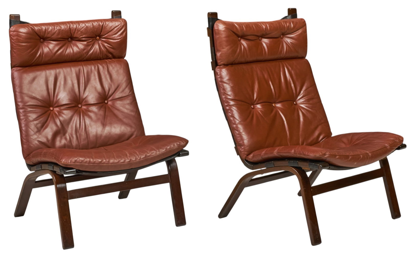 Pair of Danish Mid-Century Lounge Chairs: Pair of Danish mid-century lounge chairs featuring button-tufted brown leather upholstery, on bentwood frames height 38 in. x width 24 in. x depth 26 in.