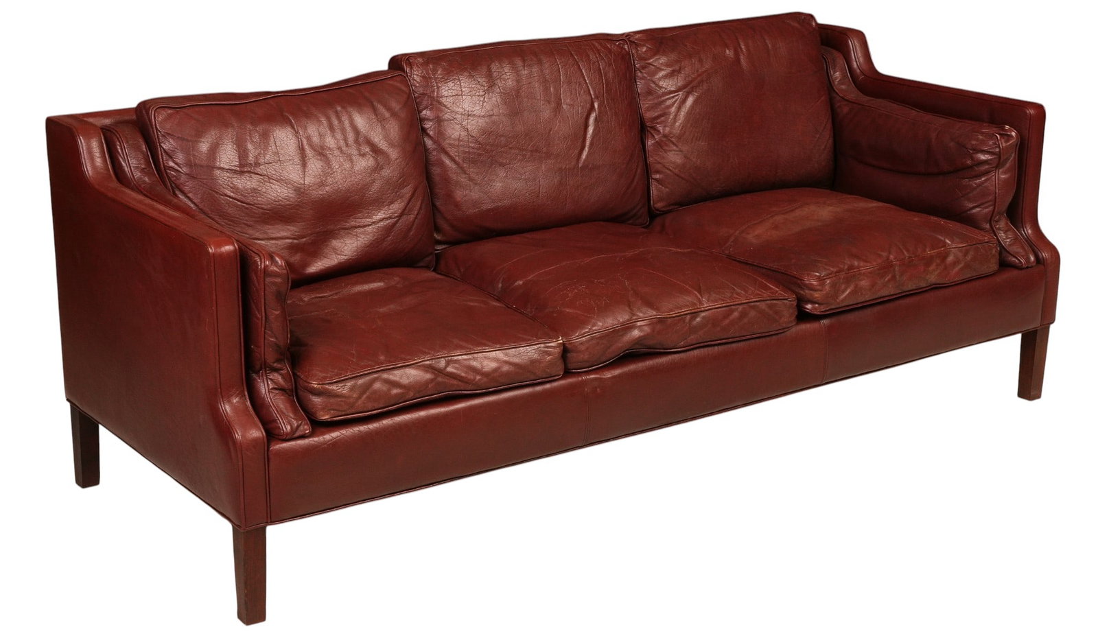 Danish Mid-Century Leather Sofa: Danish mid-century sofa, burgundy leather upholstery with loose seat, back and side cushions, upholstered frame with shaped arms, raised on square wood legs height 32 in. x width 82 in. x depth 32.5