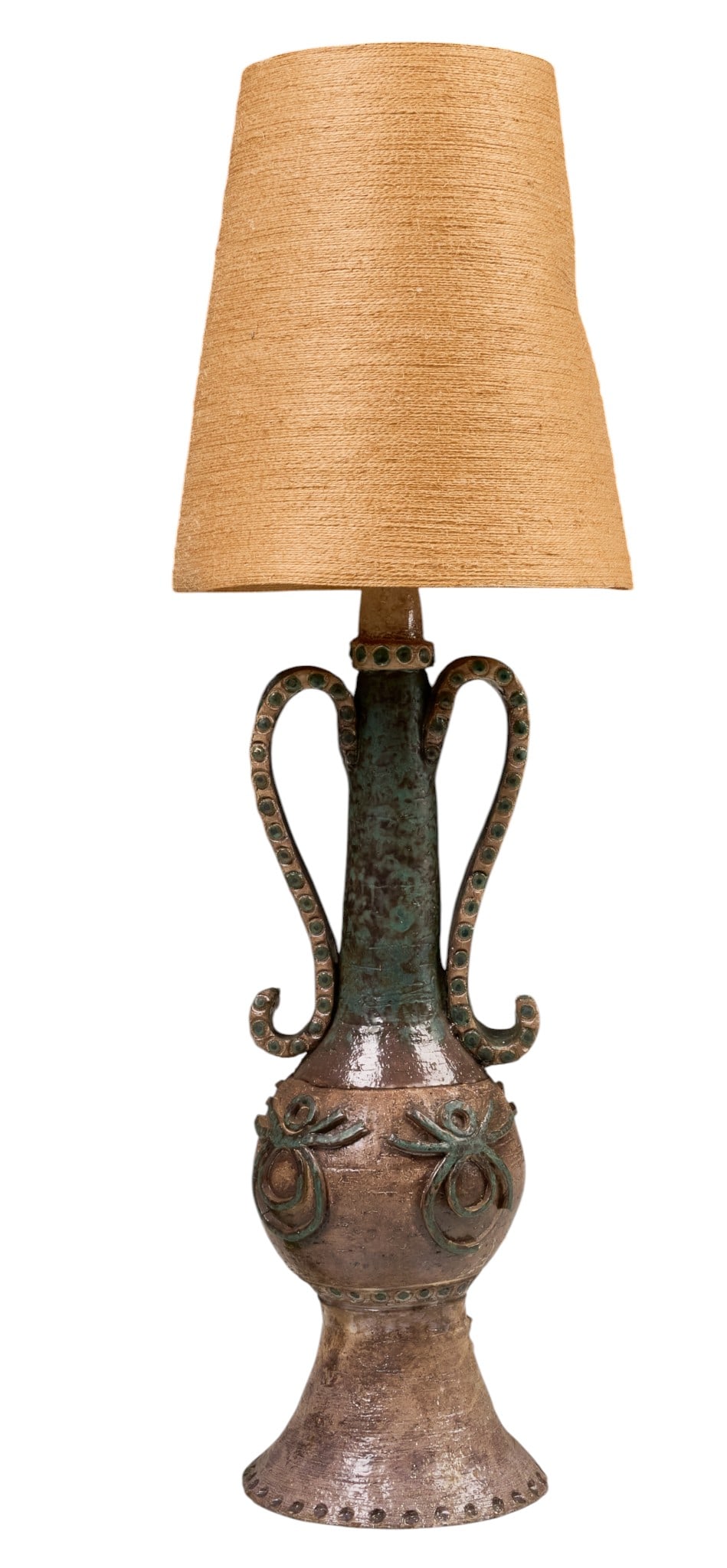 Mid-Century Studio Pottery Table Lamp: Mid-century studio pottery table lamp, sculptural stoneware body with applied loop handles and raised decoration, mottled brown and green glaze, fitted with woven shade height 48 in. x diameter 17 in.