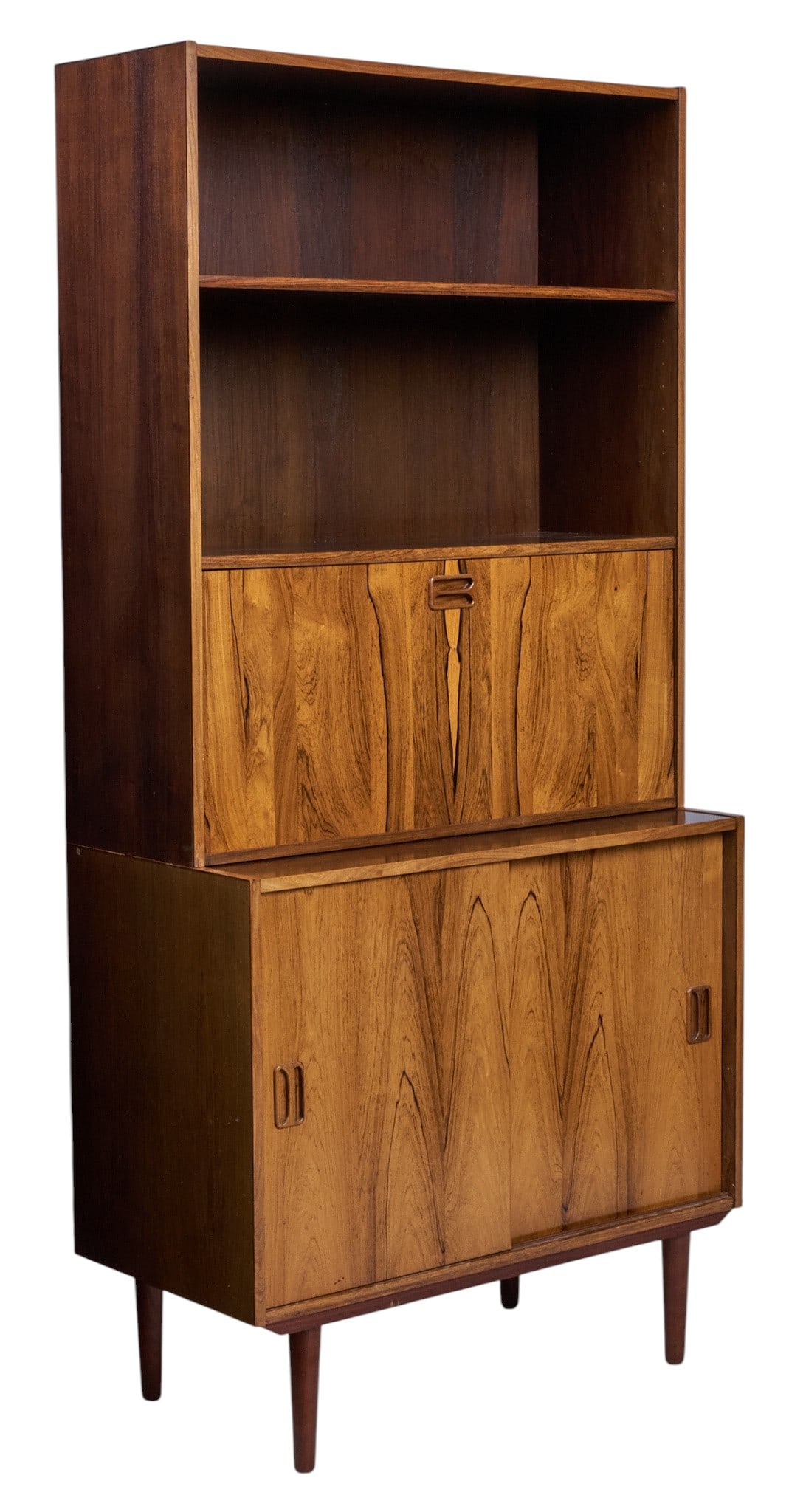 Danish Mid-Century Bookcase: Danish mid-century rosewood bookcase with open shelves, drop-front cabinet with fitted storage, and lower sliding door cabinet with single shelf, supported on pin legs height 72 in. x width 34