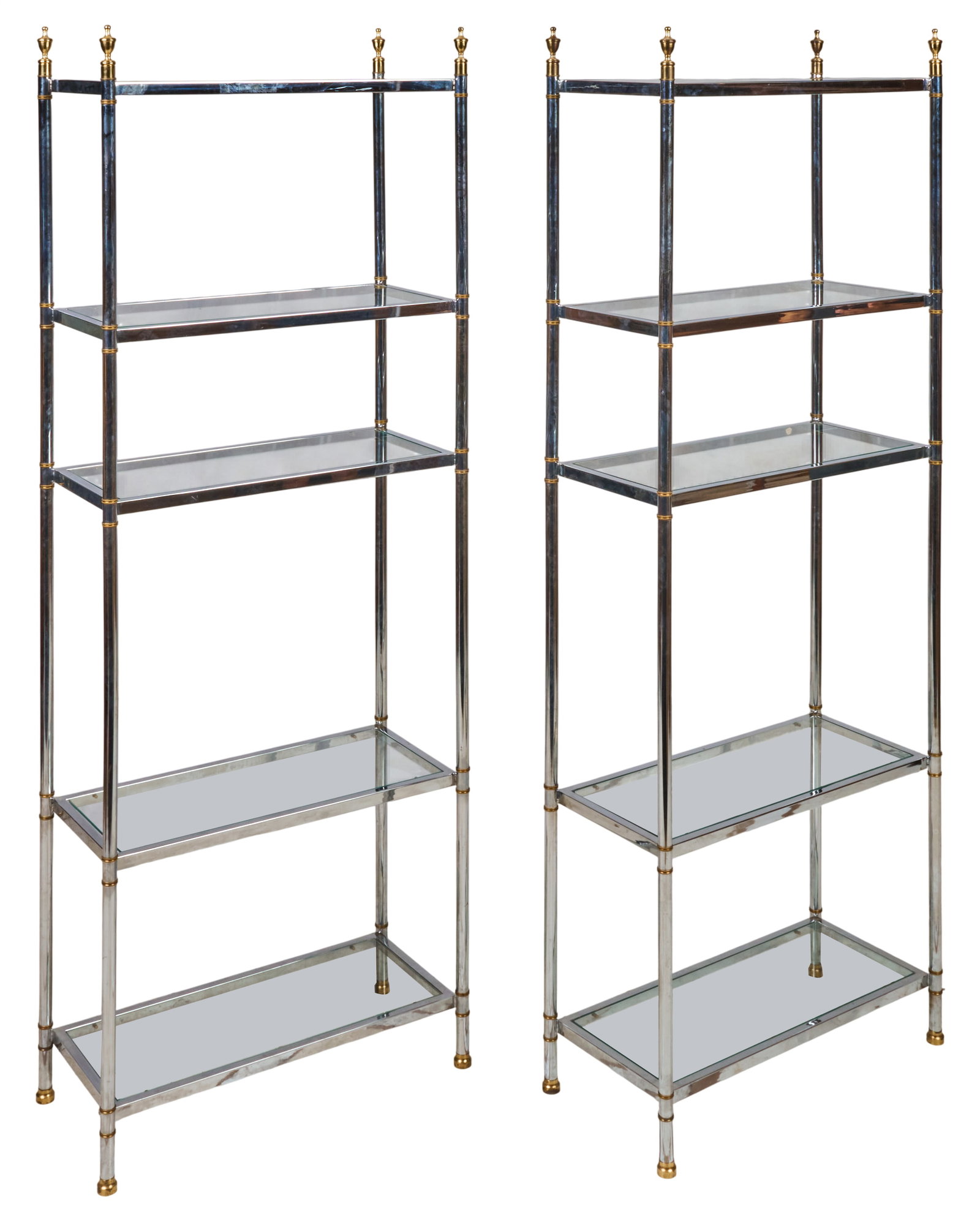 Pair of Chrome and Glass Shelf Units: Pair of shelf units featuring chrome frames with decorative gold-toned finials, each unit with four glass shelves height 81 in. x width 30 in. x depth 14 in. / each Provenance: Property