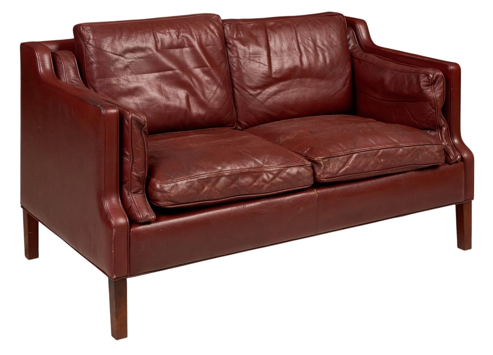 Danish Mid-Century Leather Loveseat: Danish mid-century loveseat, burgundy leather upholstery with loose seat and back cushions, upholstered frame with shaped arms, raised on square wood legs height 31 in. x width 59 in. x depth 31 in.