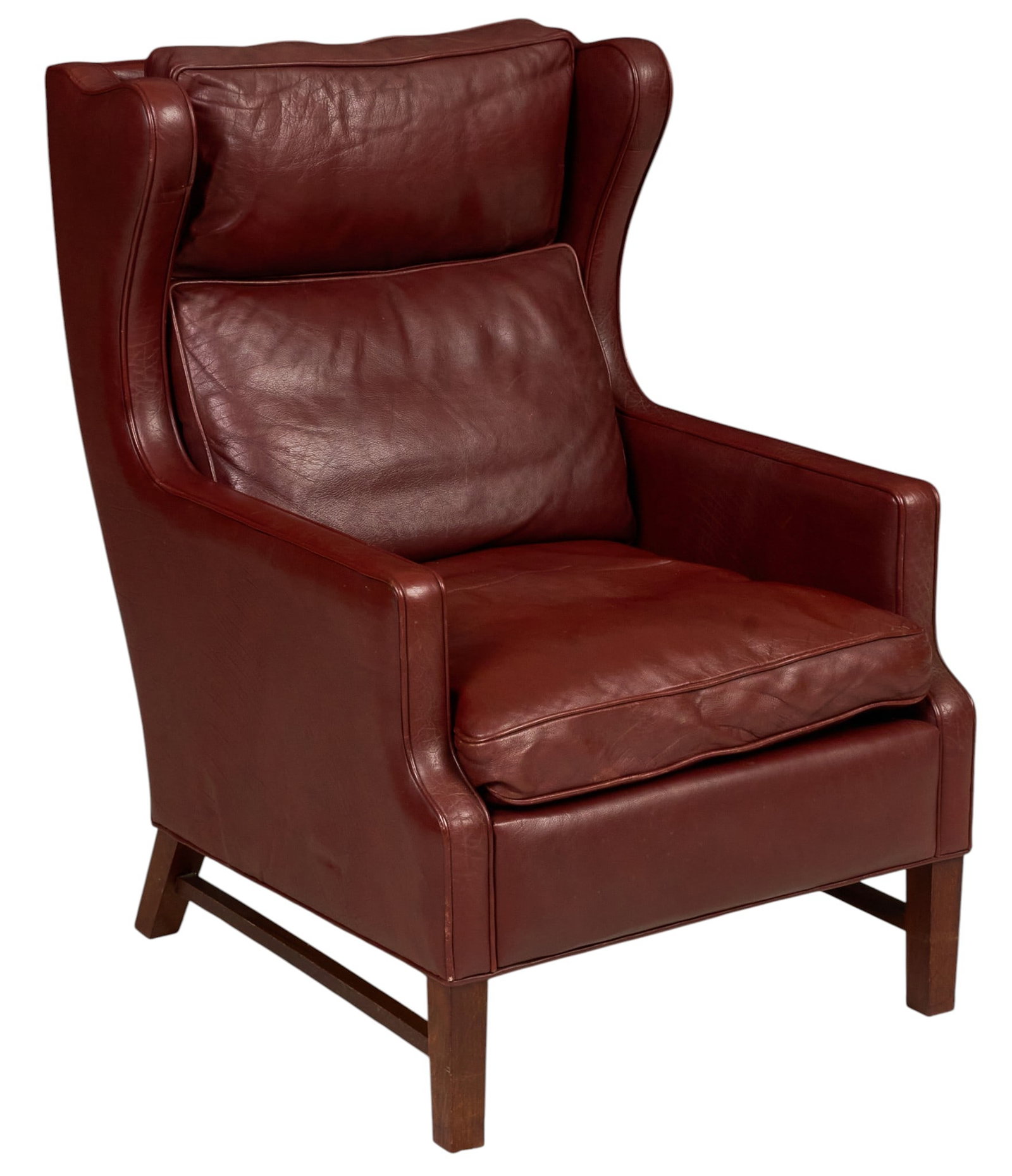 Danish Mid-Century Leather Wingback Chair: Danish mid-century wingback lounge chair, burgundy leather upholstery with loose seat, back and lumbar cushions, shaped wingback frame, raised on square wood legs joined by side stretchers height 42 i