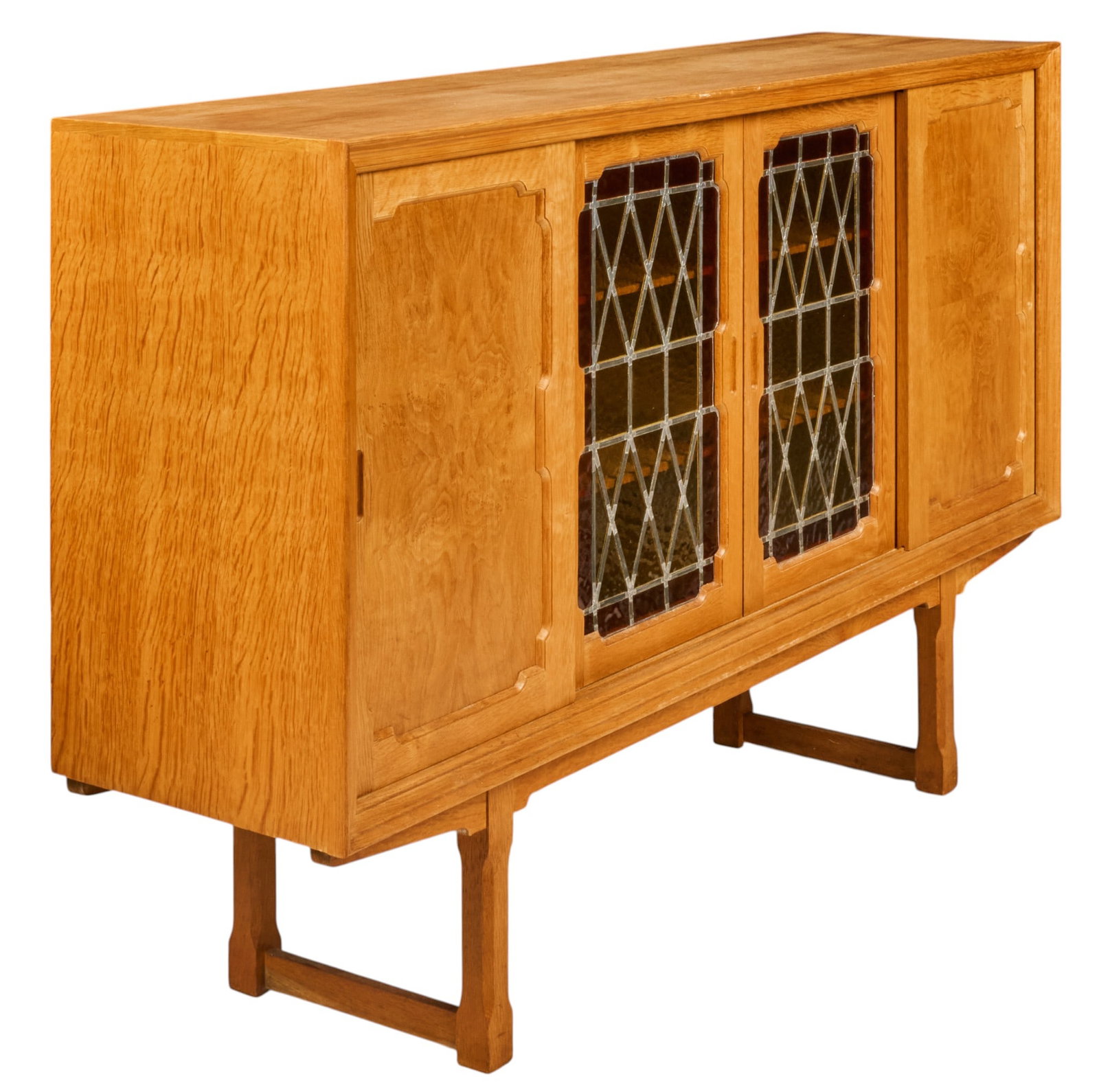Danish Mid-Century Oak Bar Cabinet: Danish mid-century oak bar cabinet, rectangular case with four sliding doors, central pair inset with geometric leaded glass panels, fitted interior with shelves and pull-out serving trays, raised on
