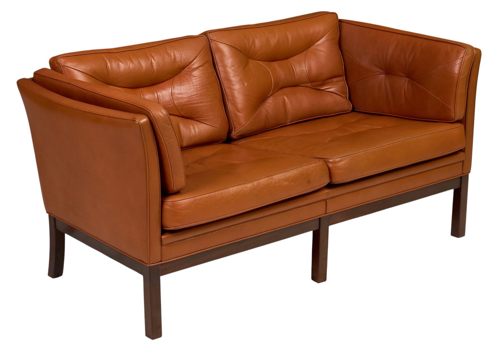Danish Mid-Century Leather Loveseat: Danish mid-century two-seat loveseat, cognac leather upholstery with loose sculptural back cushions, tufted seat cushions and padded arms, raised on a dark wood frame with square legs height 30 in. x