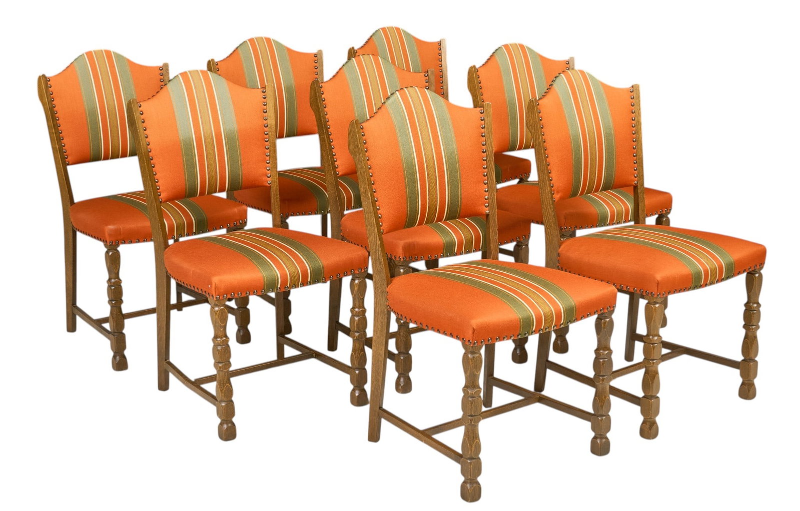 Set of (8) Mid-Century Dining Chairs: Set of eight mid-century dining chairs, Spanish Revival influence, oak frames with shaped upholstered backs and seats in orange and green striped fabric, brass nailhead trim, carved front legs and str