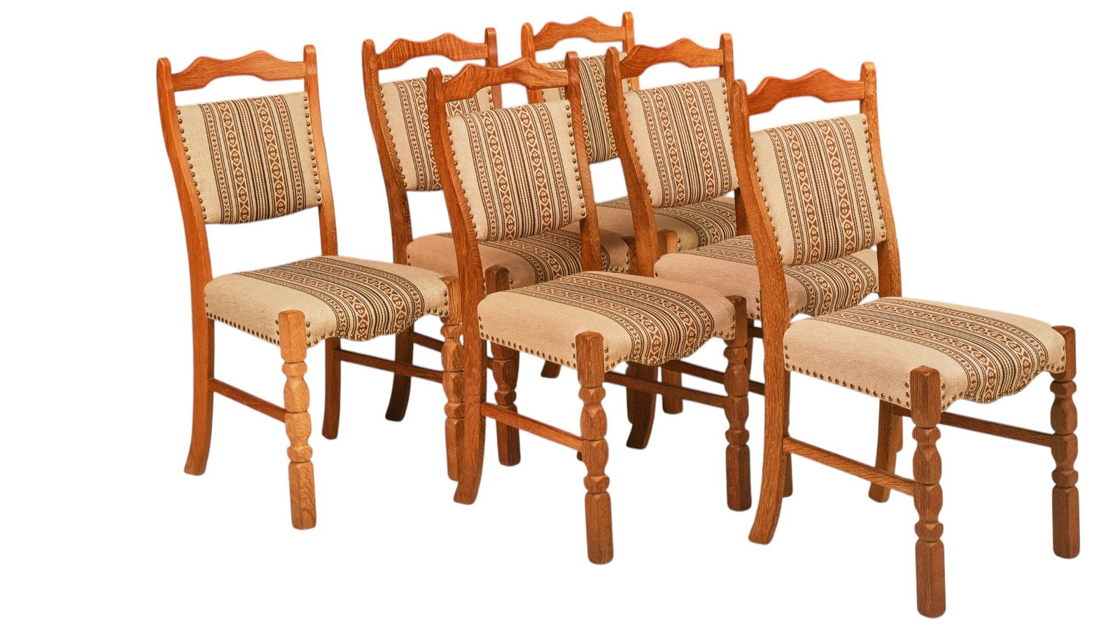 Set of (8) Danish Mid-Century Chairs: Set of eight mid-century dining chairs, oak frames with shaped crest rails, upholstered backs and seats in cream and brown geometric striped fabric, brass nailhead trim, turned front legs joined by st