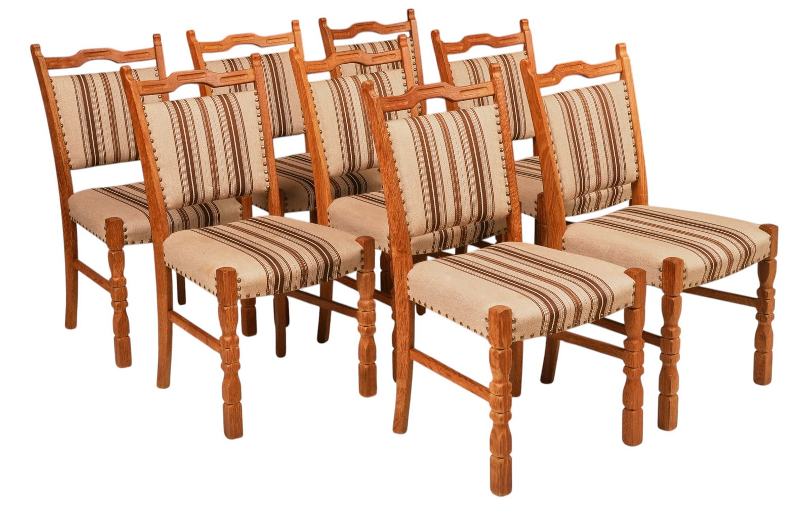 Set of (8) Danish Mid-Century Oak Dining Chairs: Set of eight Danish mid-century oak dining chairs, shaped ladder backs, upholstered backs and seats in cream and brown striped fabric with brass nailhead trim, turned front legs and stretcher bases