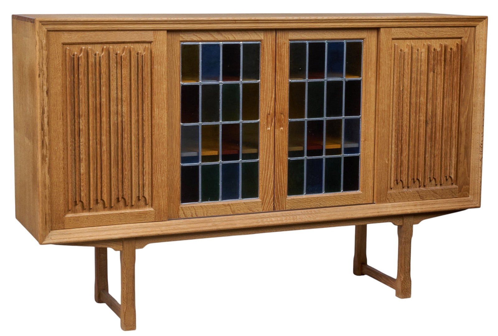 Danish Mid-Century Credenza: Danish mid-century credenza with two decoratively carved sliding doors, and two leaded glass sliding doors that open to reveal interior shelving and flatware trays height 45 in. x width 71 in. x
