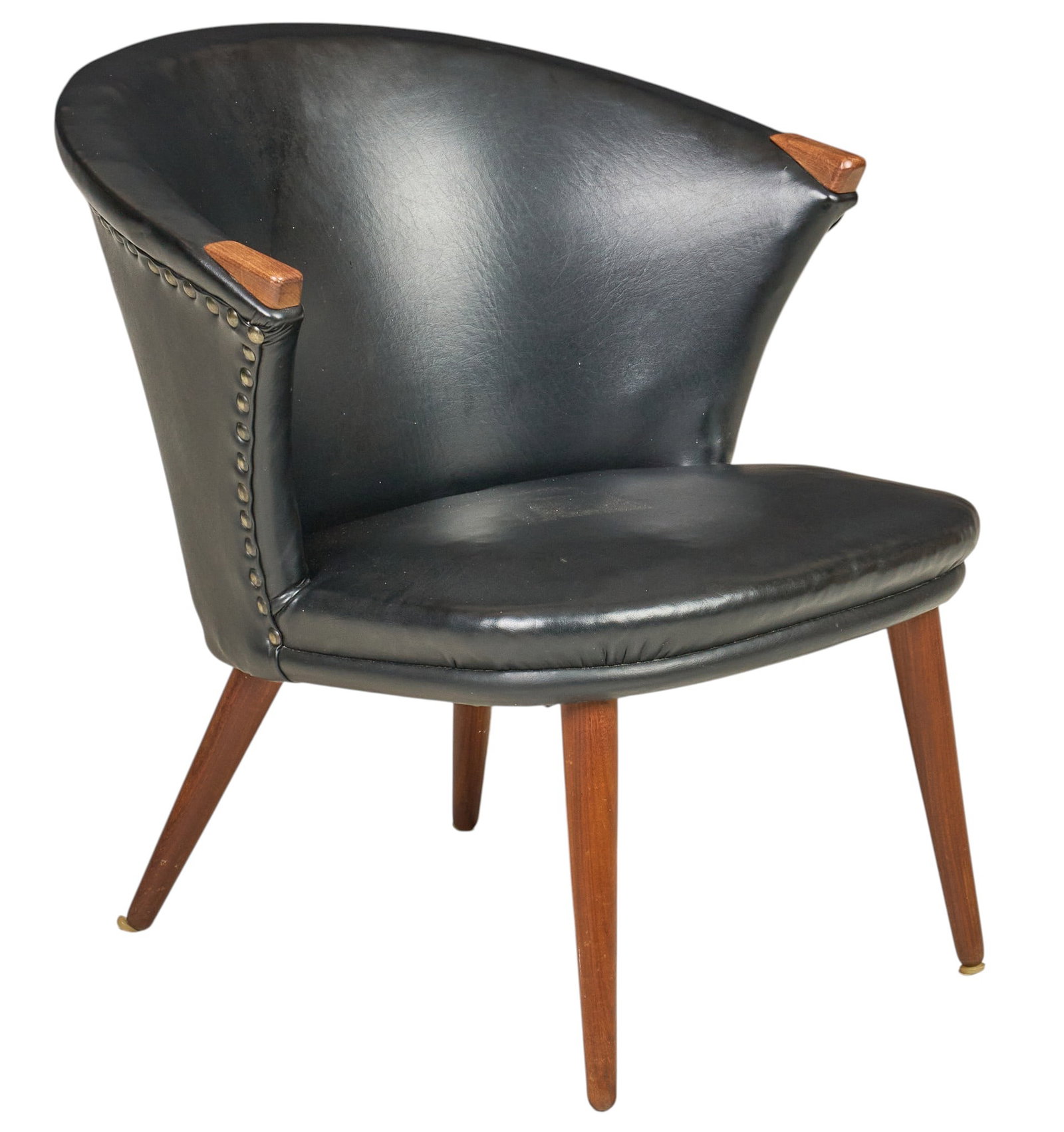 Danish Mid-Century Leather Barrel Chair: Danish mid-century barrel chair, black leather upholstery with brass nailhead trim, exposed teak hand rests, raised on splayed tapered teak legs with brass sabots height 26.5 in. x width 26.5 in. x de