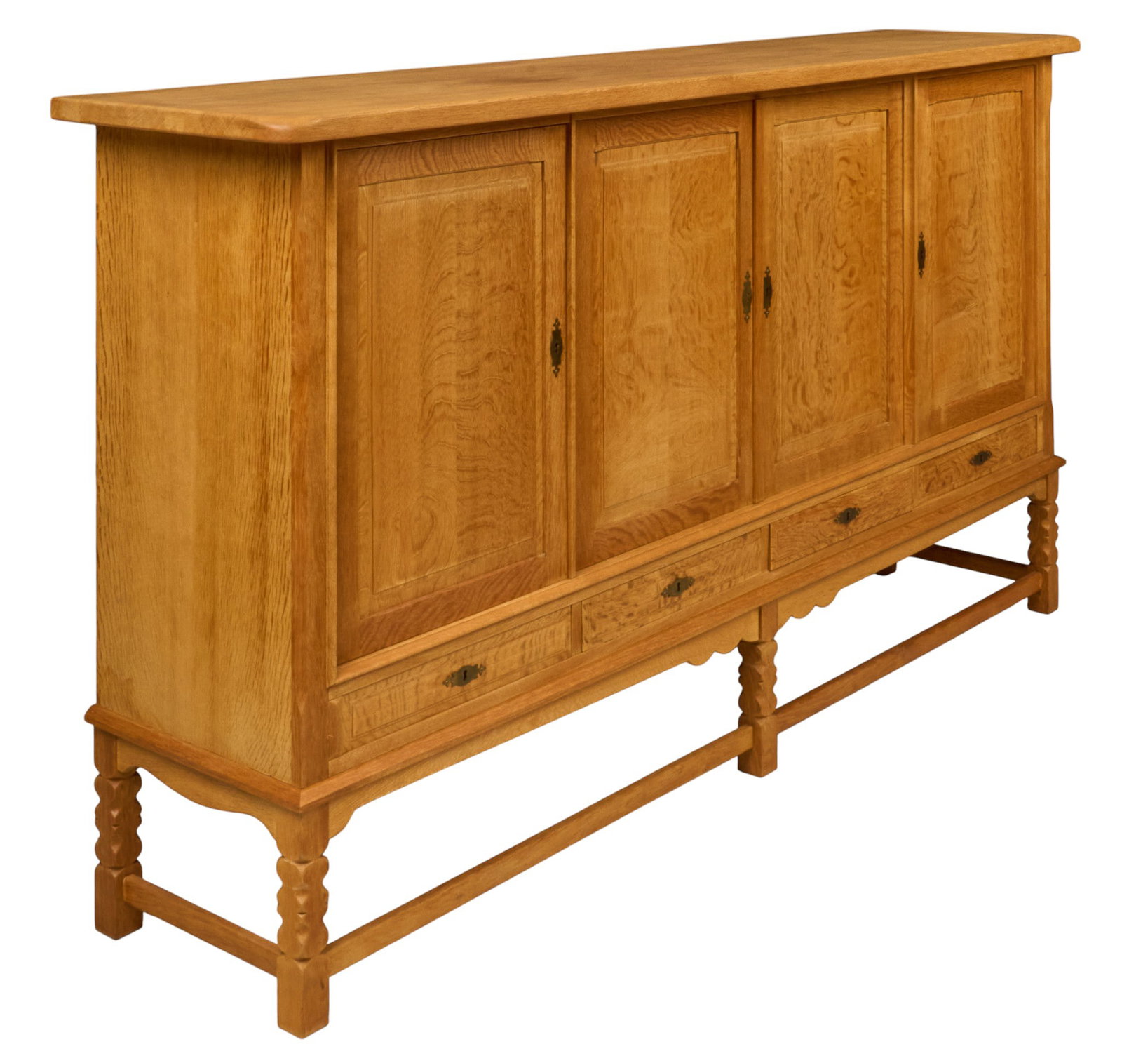 Henning Kjaernulf, Mid-Century Credenza: Henning Kjaernulf (Denmark) oak mid-century credenza with four carved cabinet doors opening to shelved interiors and four lower drawers lined with green felt, supported on carved block legs height 47