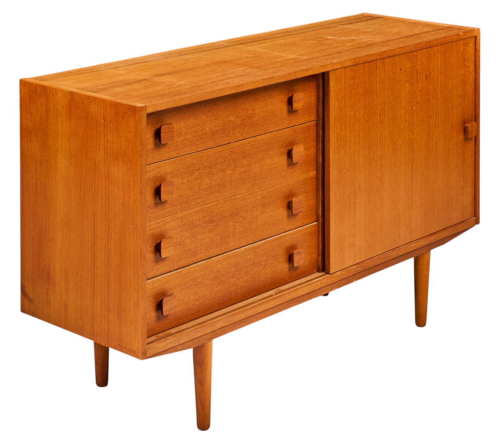 Danish Mid-Century Credenza: Danish mid-century credenza with recesses stack of four drawers, and single sliding cabinet door that opens to interior with single shelf, supported on pin legs height 24.5 in. x width 48 in. x depth