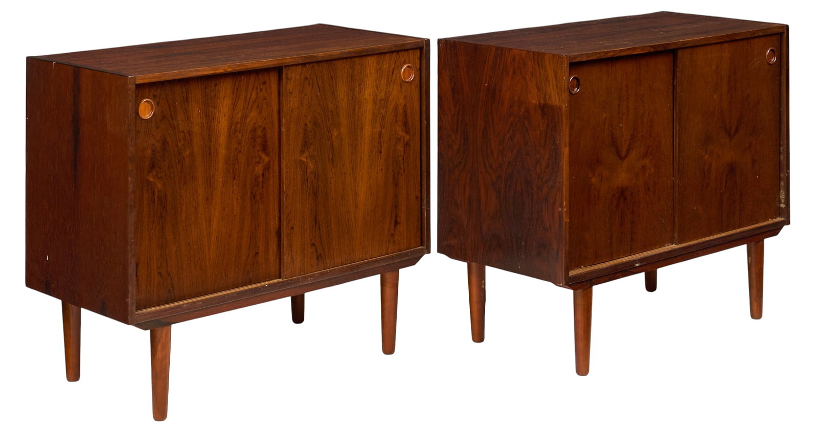 Pair of Danish Mid-Century Credenzas: Pair of Danish mid-century credenzas with sliding cabinet doors and interior shelving, supported on pin legs height 29 in. x width 33.5 in. x depth 16 in. / each 