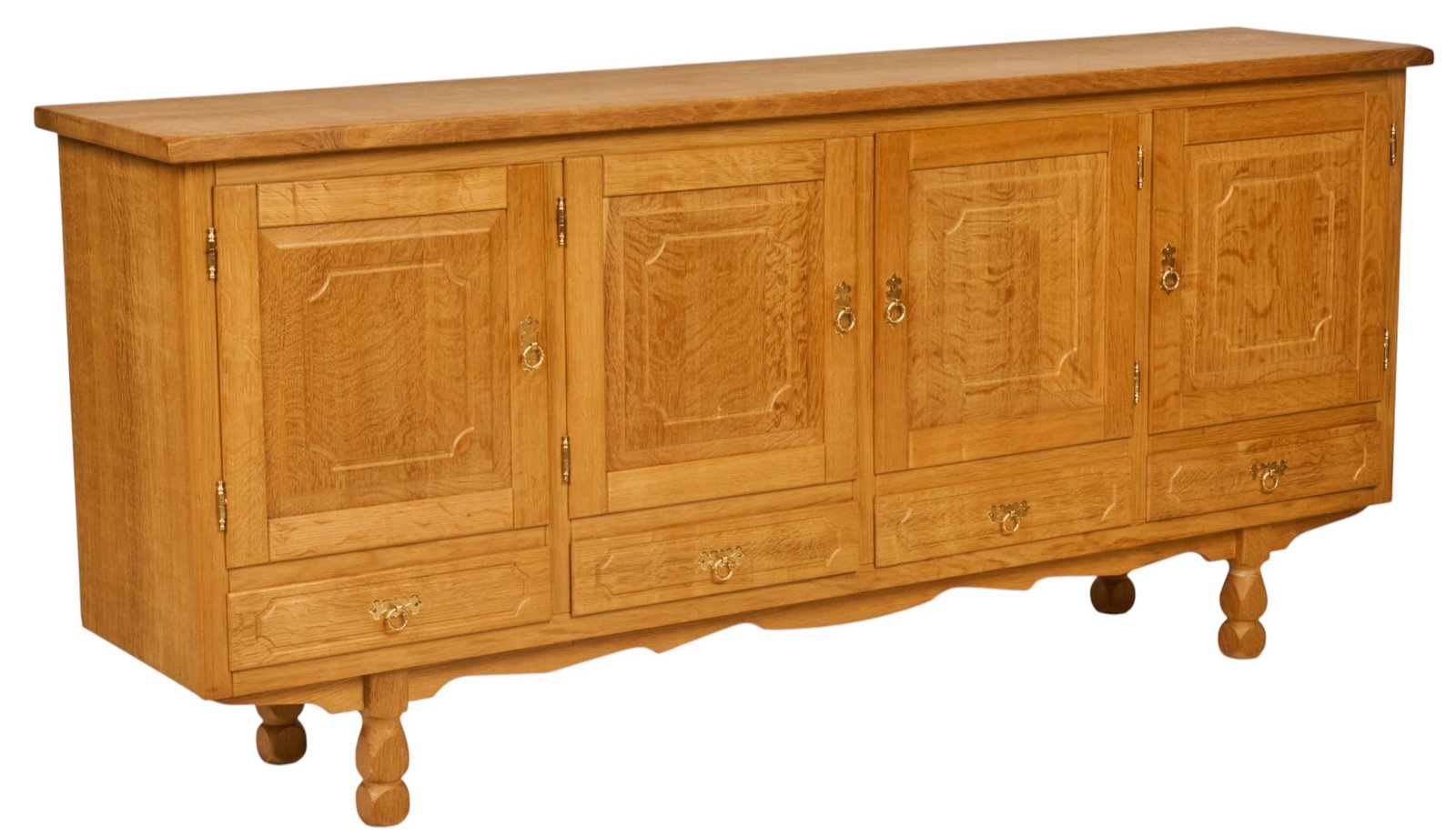 Henning Kjaernulf, Mid-Century Credenza: Henning Kjaernulf (Denmark) oak mid-century credenza with four carved and paneled cabinet doors opening to shelved interior, and four lower drawers lined with green felt height 36 in. x width 79 in.