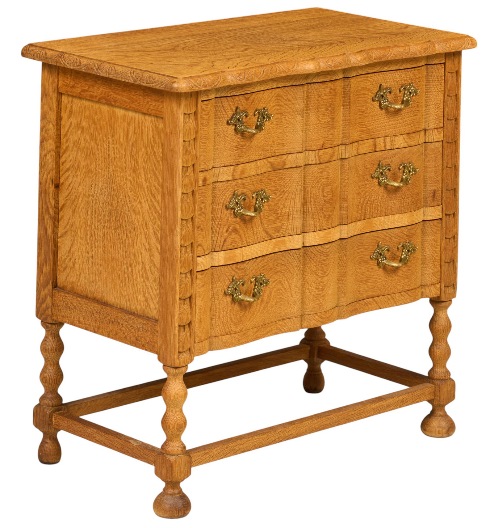 Henning Kjaernulf, Mid-Century Chest of Drawers: Henning Kjaernulf (Denmark) oak mid-century chest of three drawers with serpentine front and decorative brass pulls, supported on turned legs with stretchers height 24 in. x width 25.5 in. x depth