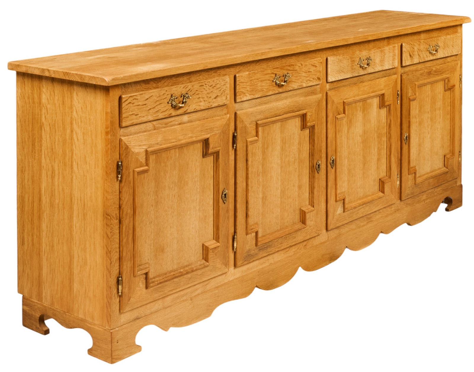 Henning Kjaernulf, Mid-Century Credenza: Henning Kjaernulf (Denmark) mid-century credenza with four drawers with decorative brass pulls above four paneled cabinet doors opening to two shelved cabinets, supported on scalloped base, includes