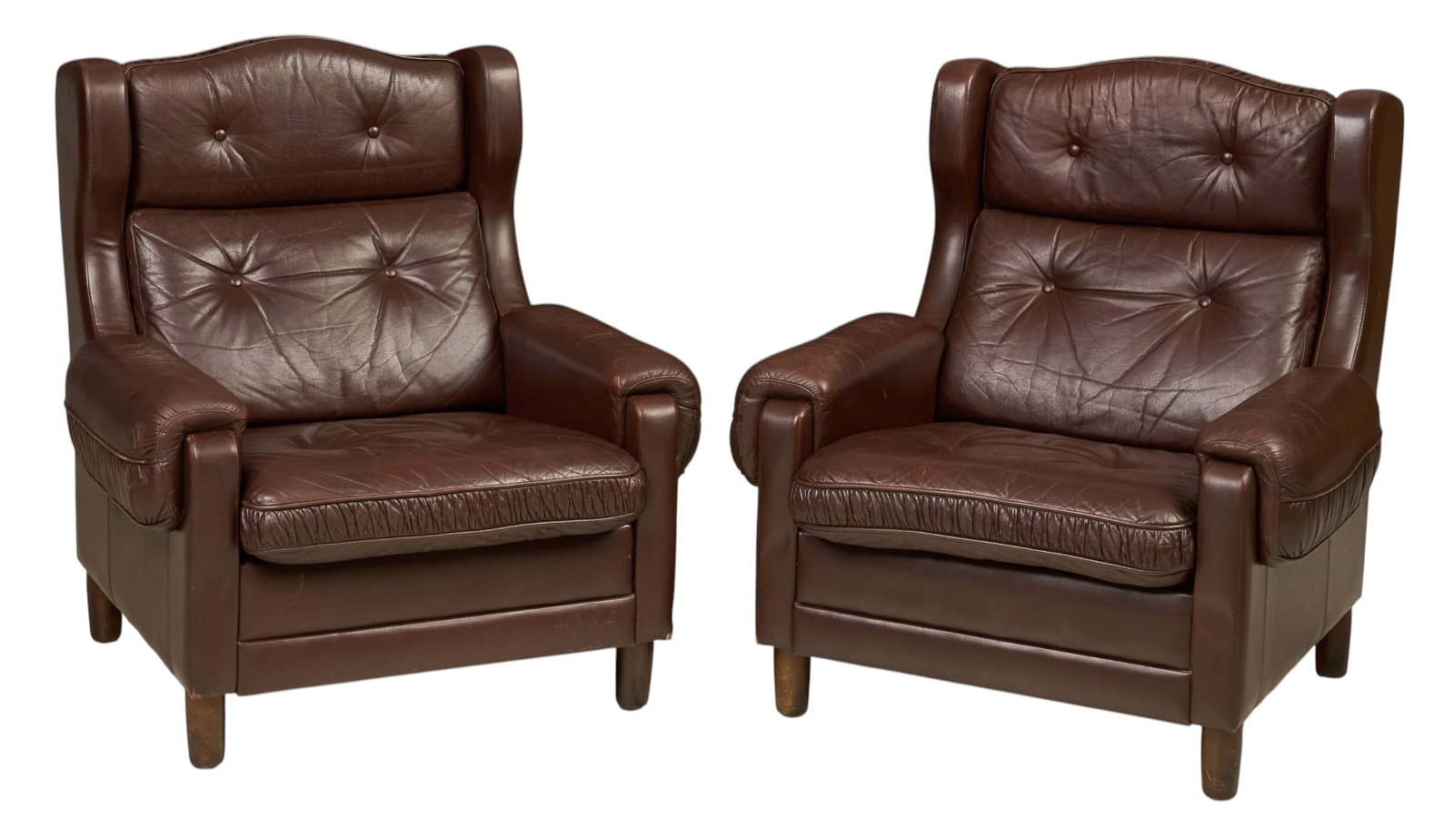 Pair of Danish Mid-Century Armchairs: Pair of Danish mid-century brown leather armchairs, with button tufted cushions and wingback frame height 35 in. x width 34.5 in. x depth 37 in. / each