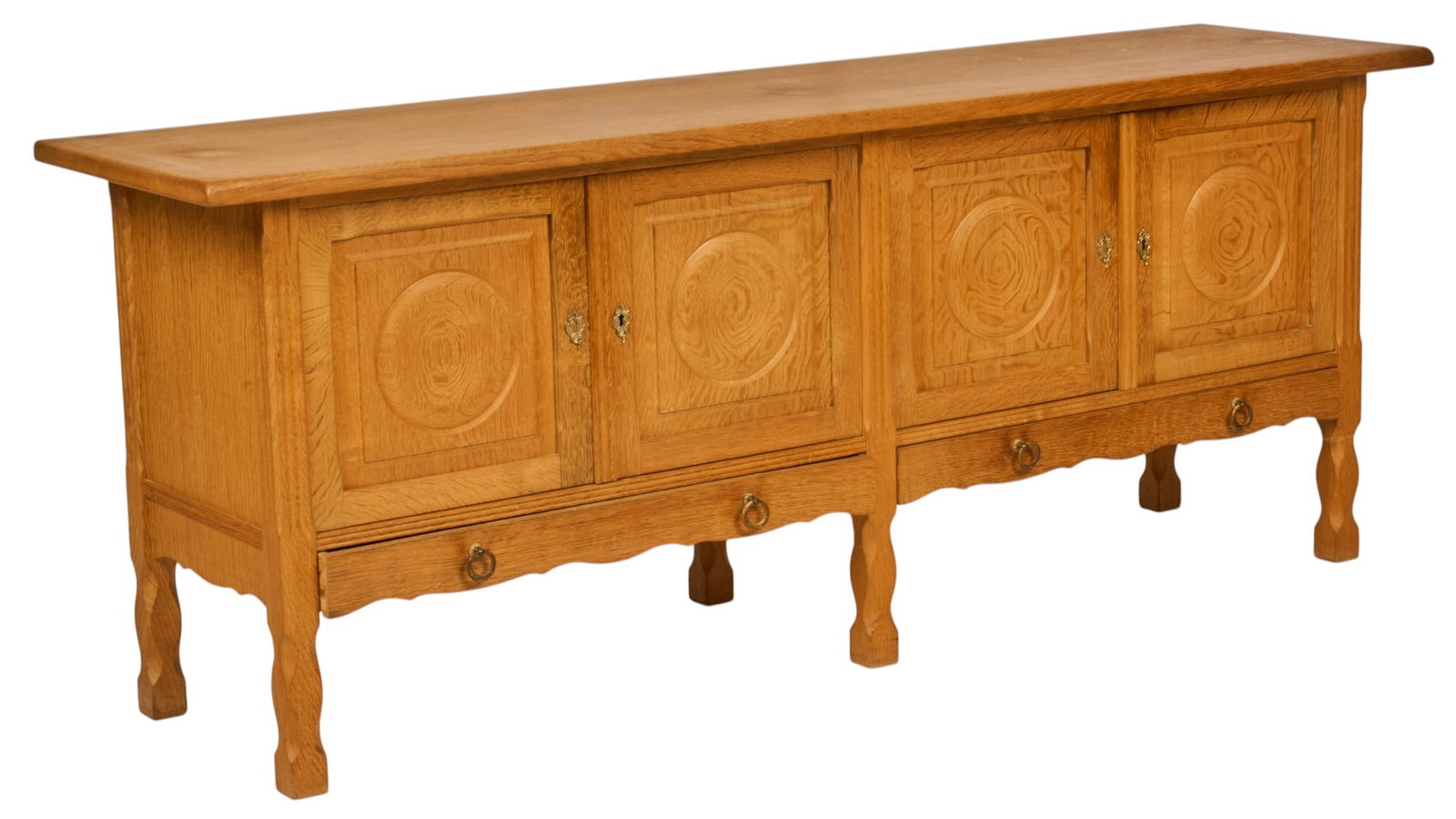 Henning Kjaernulf, Mid-Century Credenza: Henning Kjaernulf (Denmark) oak mid-century credenza with four carved cabinet doors opening to shelved interior, above two drawers lined with green felt with ring pulls, supported on block legs