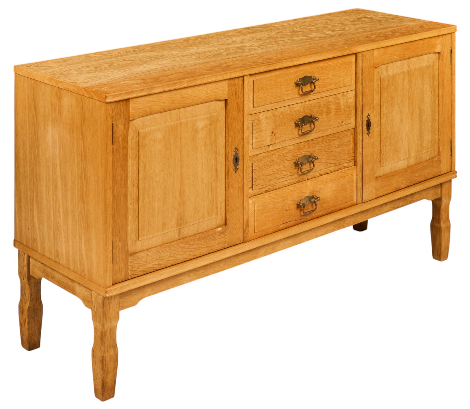 Danish Mid-Century Oak Sideboard: Danish oak Mid-Century sideboard, rectangular top above a central bank of four drawers with brass bail pulls, flanked by paneled cabinet doors opening to shelved interiors, raised on shaped legs heigh