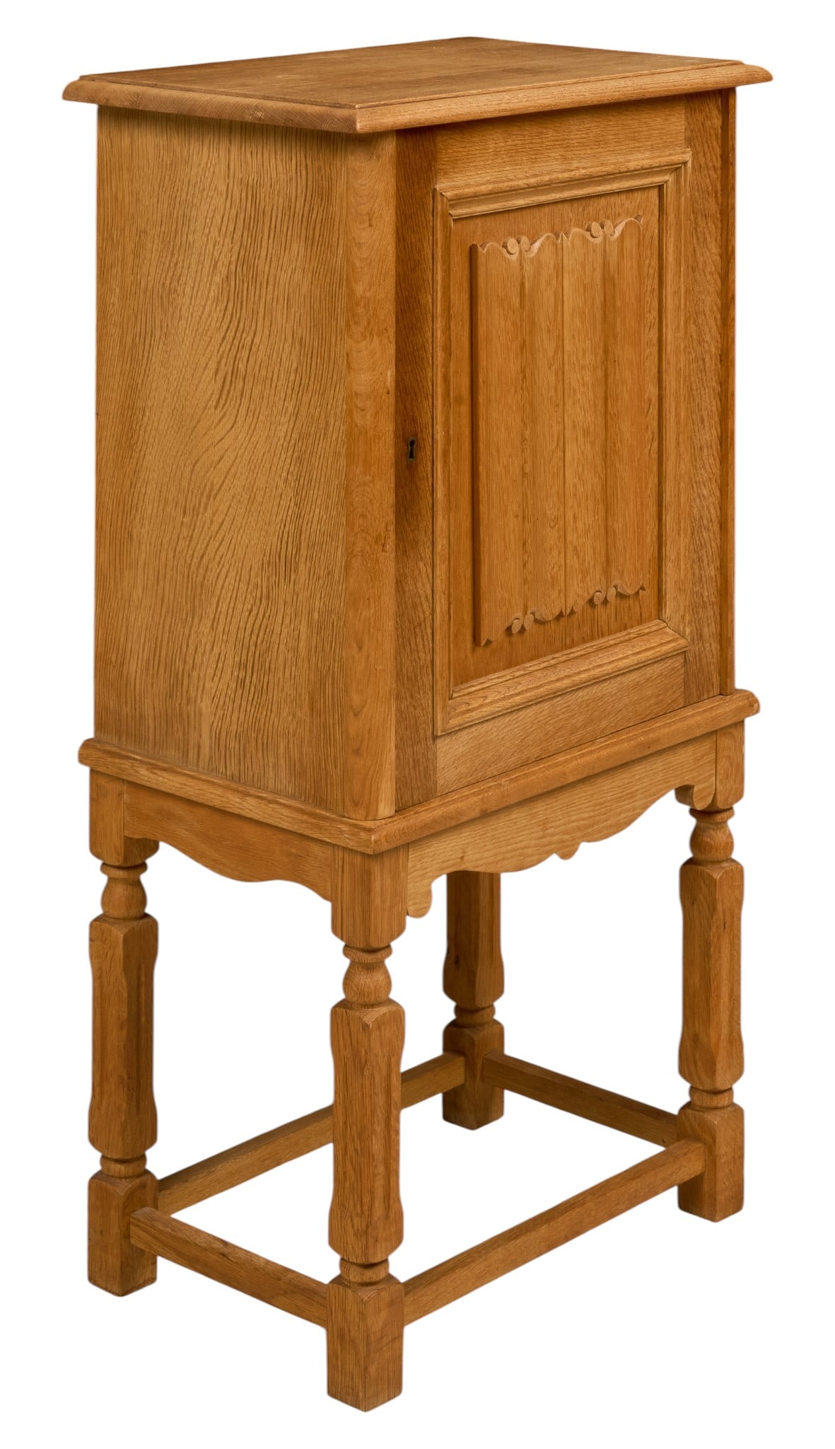 Mid-Century Oak Cabinet on Stand: Mid-century oak cabinet on stand, single paneled door with carved foliate details, raised on turned and faceted legs joined by stretchers height 41.5 in. x width 22 in. x depth 14.5 in.