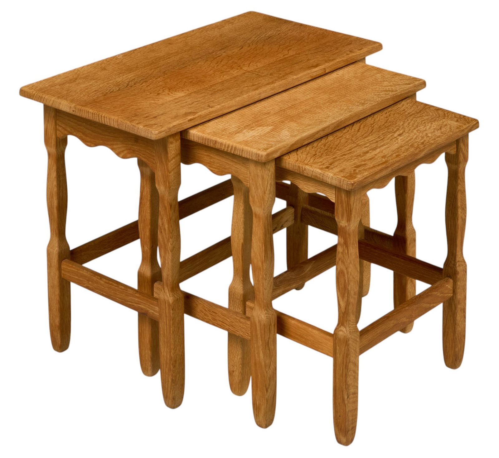 Set of Three Mid-Century Oak Nesting Tables: Set of three mid-century oak nesting tables, rectangular tops, shaped aprons, turned legs with stretchers largest, height 19.5 in. x width 25 in. x depth 14 in.