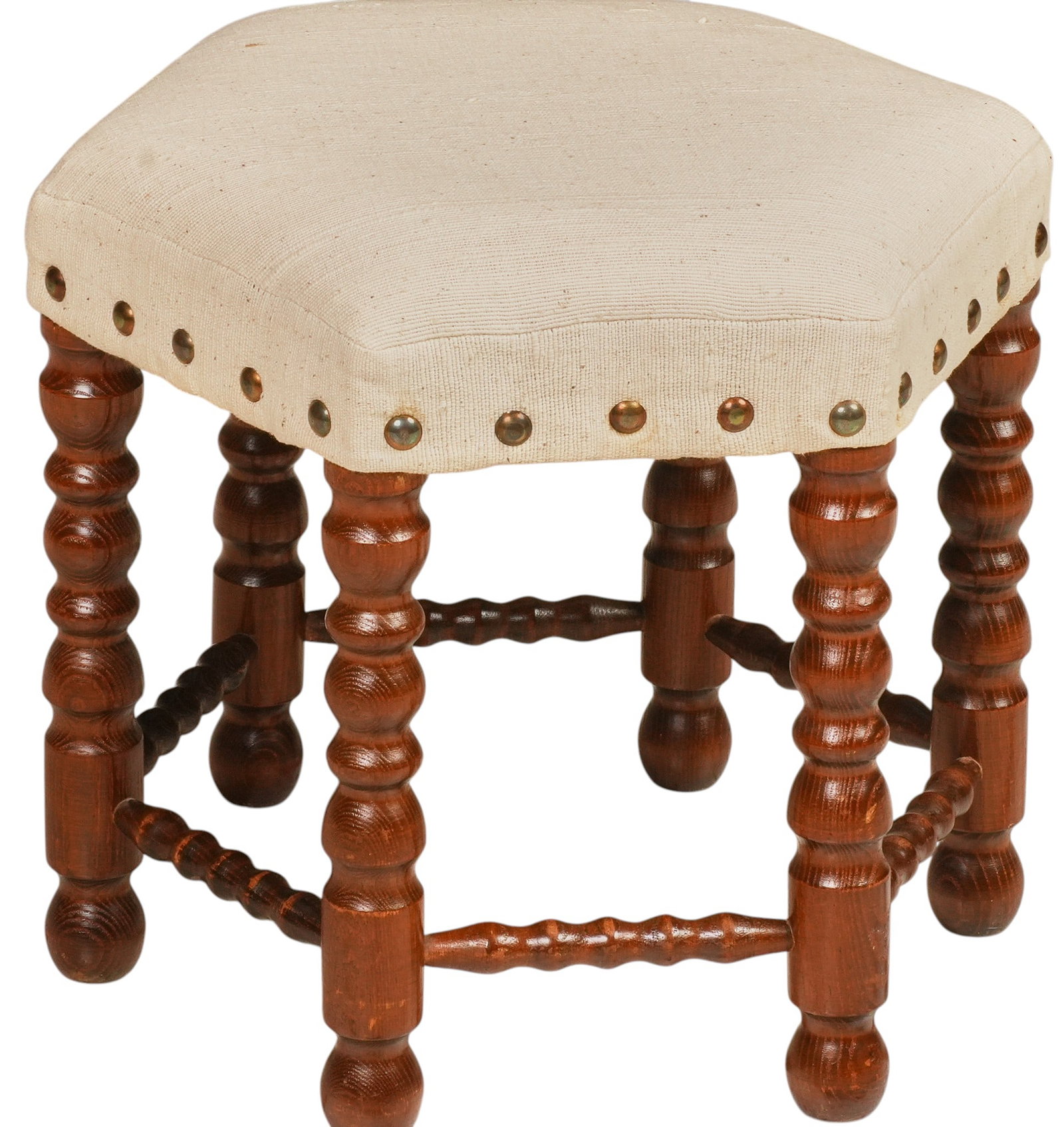 Mid-Century Upholstered Stool: Mid-century wood stool, cream upholstered seat with brass nailhead trim, turned legs joined by turned stretchers height 14 in. x width 16 in. x depth 14 in.