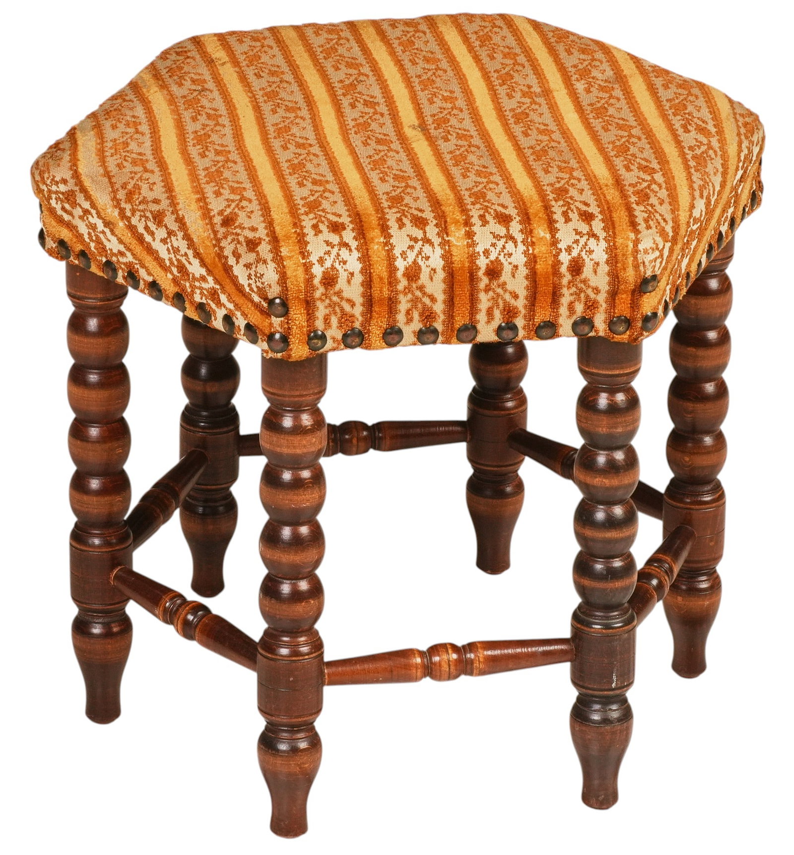 Mid-Century Upholstered Stool: Mid-century wood stool, orange and cream patterned upholstery with brass nailhead trim, turned legs joined by turned stretchers height 14 in. x width 14 in. x depth 16 in.