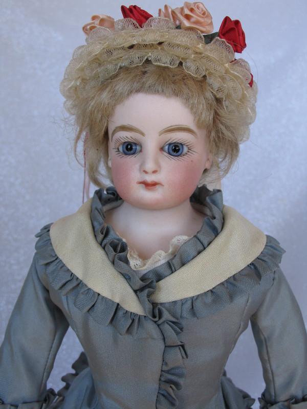 Antique French Fashion Poupee 15" (38cm) c1890s bisque: Antique French Fashion Poupee 15" (38cm) c1890s bisque shoulder head incised wide-low on the front rim "M 1". Closed red mouth with gloss red centerline, paperweight blue glass eyes, bold black angled