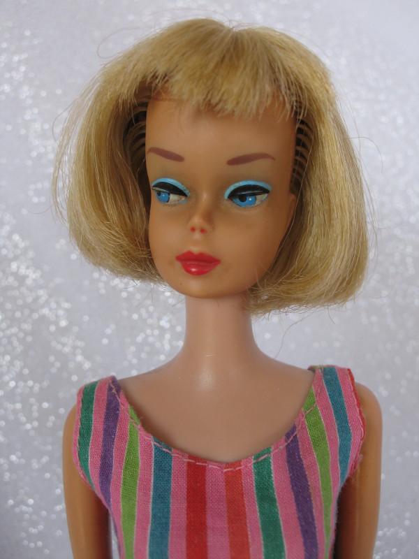 Mattel 1966 Barbie American Girl. Blonde center part: Mattel 1966 Barbie American Girl. Blonde center part hair, front fringe, lush under chin-length bangs, raspberry lips, bendable knees. Excellent original painted features, two fingers without nail pol
