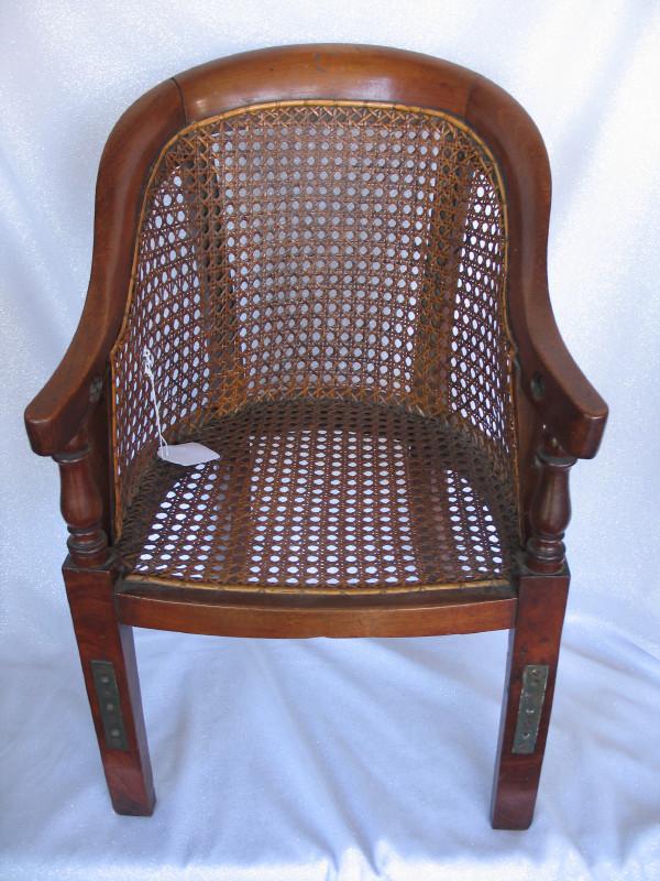 Two similar Regency Child mahogany chairs. One has very: Two similar Regency Child mahogany chairs. One has very good caned seating but missing handrail. Other with feet stretchers has repair to side hand rest and upright and some caned seating minor flaw.