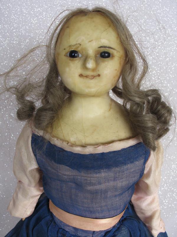 English Slit Head Wax over c1860. Wax over papier: English Slit Head Wax over c1860. Wax over papier mache composition shoulderhead 19" (48cm). Round face with inserted pupiless glass eyes, closed smiling mouth. Aged condition with general wax crazing
