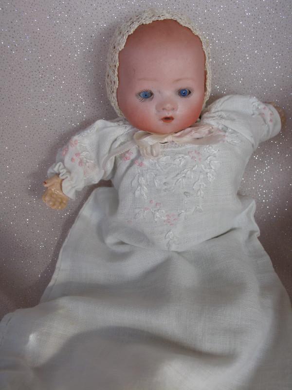 Miniature Louis Amberg & Son Newborn 862 baby, bisque: Miniature Louis Amberg & Son Newborn 862 baby, bisque 8" (20cm). Blue glass sleep eyes, fine lashes, open red mouth with no teeth, sprayed brown hair. Kapok filled cloth body, composition forearms, pa
