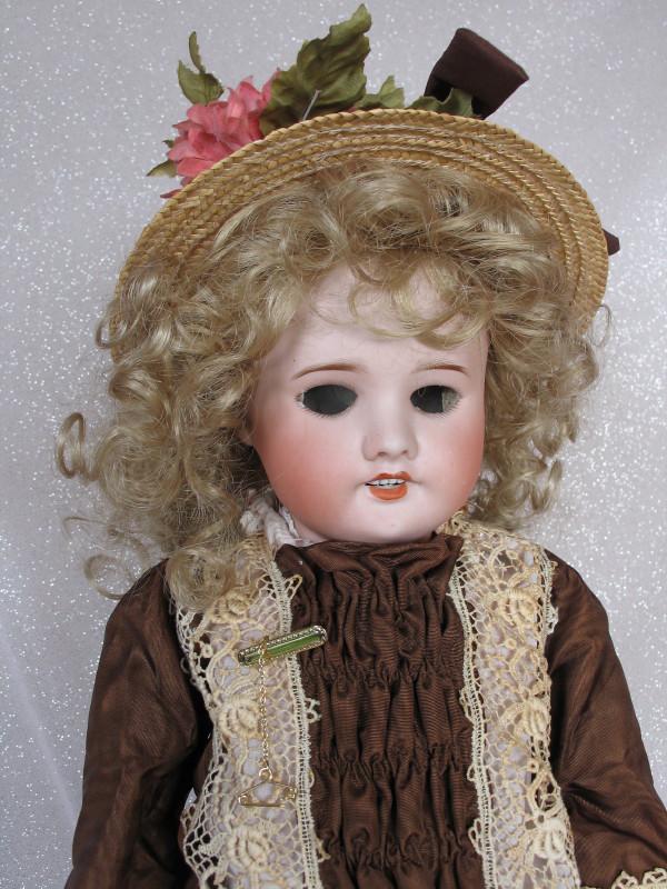 French S. F. B. J. 60 child bisque 21. 5" (55cm).: French S. F. B. J. 60 child bisque 21. 5" (55cm). Large 'U' shaped reglue from front pate rim, under ear to back pate rim. Blue glass sleep eyes are loose inside the head, angled fine lashes, paint fl