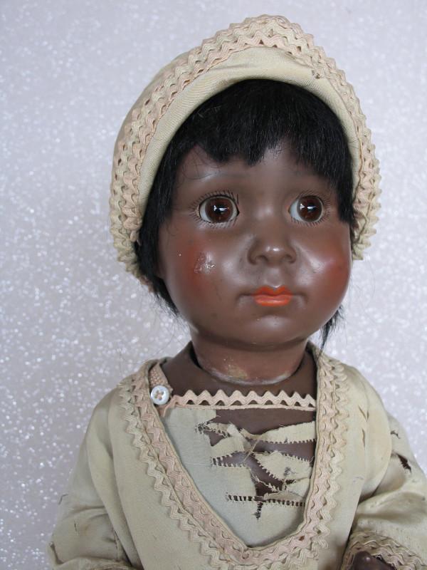 German Mago toddler brown clay composition 15" (38cm): German Mago toddler brown clay composition 15" (38cm) c1930s, incised "Germany//Mago//494 6/0". Brown glass sleep eyes, angled lashes, closed red mouth, blushed cheeks with right rub, black applied or