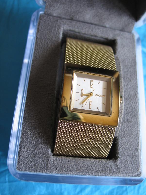 Three used vintage Ladies Watches . DKNY in box with: Three used vintage Ladies Watches . DKNY in box with 3cm wide gold band . Lorus and Renoir with decorative gold bands .