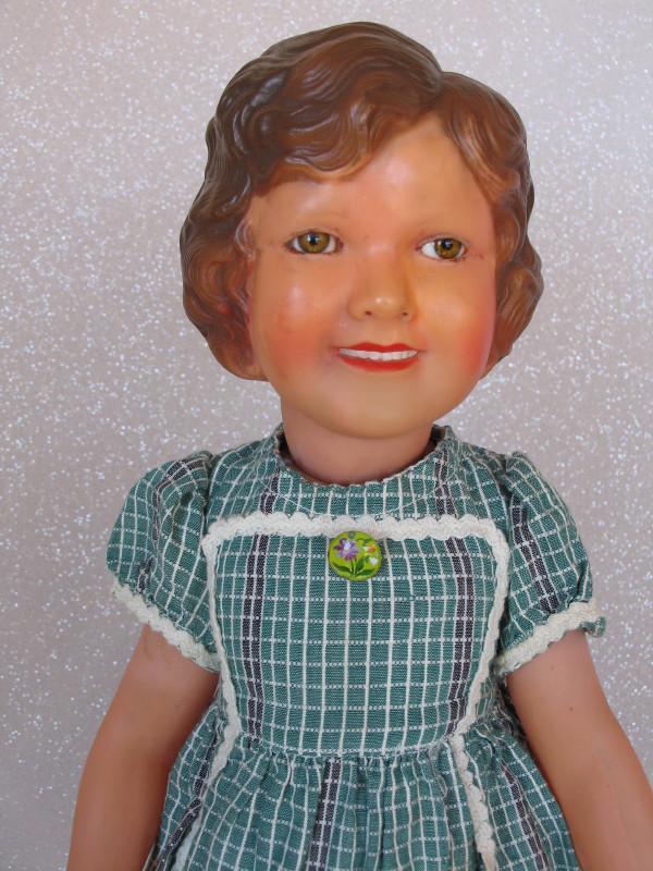 French Petitcollin "Marie-France" (Shirley Temple): French Petitcollin "Marie-France" (Shirley Temple) celluloid, 19.25" (49cm) 1940. Deep molded brown curl hair, set acetate hazel eyes, wide-open smile mouth with molded teeth, green cotton dress origi